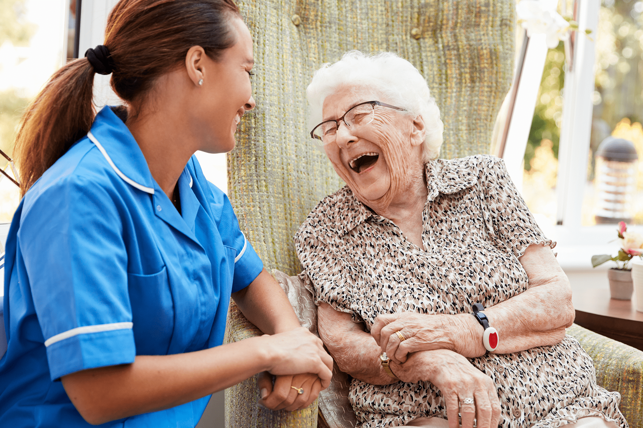 Elderly Woman Laughing Together With The Nurse